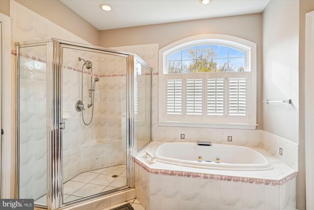 bathroom featuring shower with separate bathtub