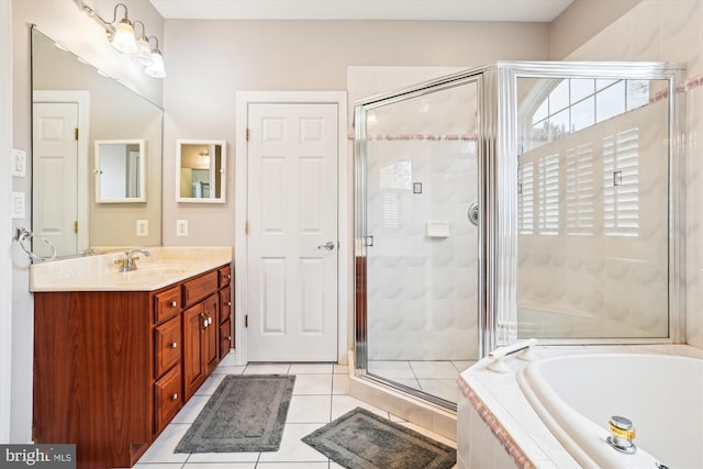 bathroom with tile patterned floors, separate shower and tub, and vanity