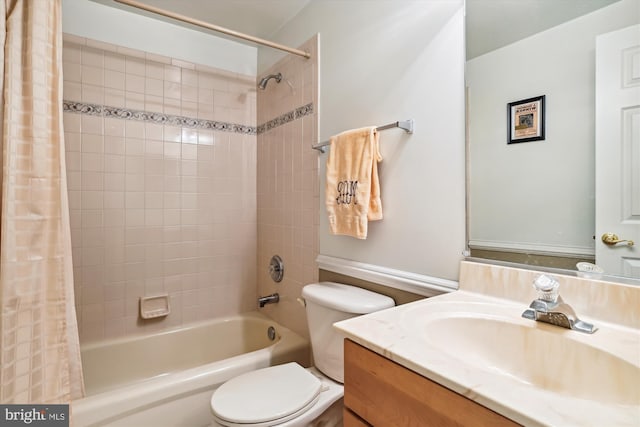 full bathroom with shower / tub combo with curtain, vanity, and toilet