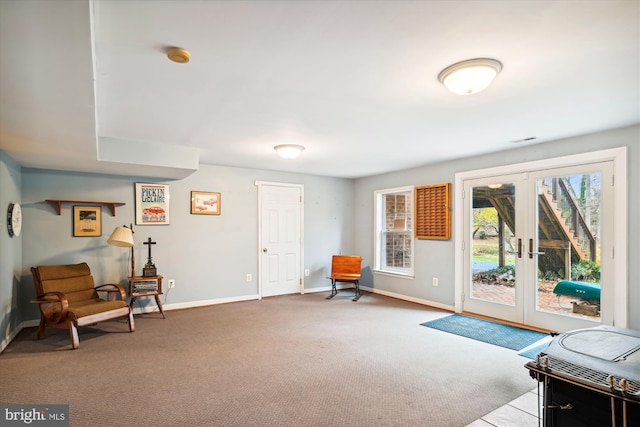 living area with french doors and light colored carpet