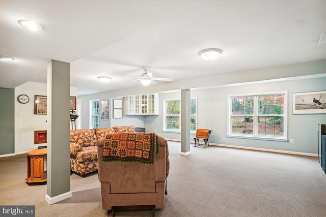 living room featuring ceiling fan and light colored carpet