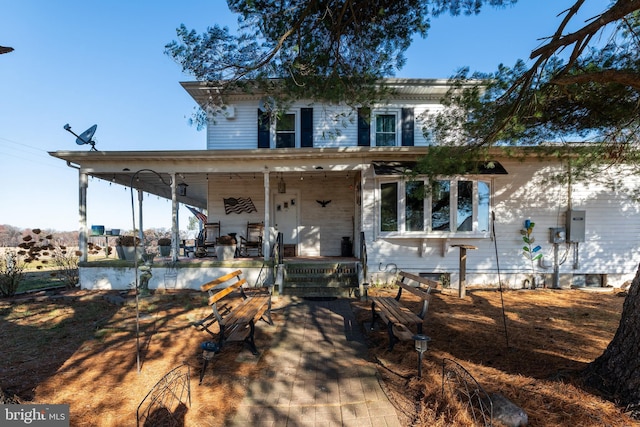 back of house featuring covered porch