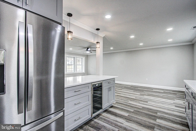 kitchen with gray cabinetry, hanging light fixtures, beverage cooler, and stainless steel refrigerator with ice dispenser