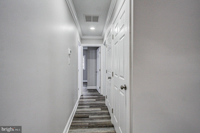 corridor with dark hardwood / wood-style flooring and crown molding