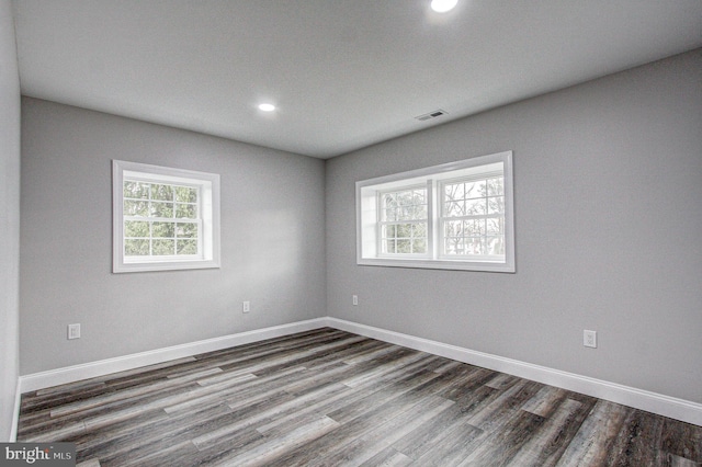 unfurnished room featuring dark hardwood / wood-style flooring