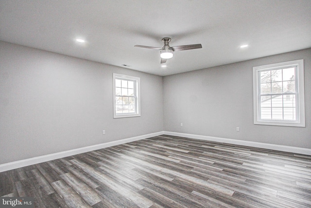 unfurnished room with dark hardwood / wood-style flooring and ceiling fan