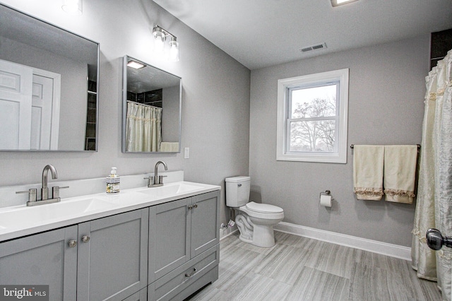 bathroom with a shower with shower curtain, vanity, toilet, and wood-type flooring