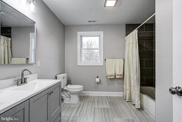 full bathroom featuring vanity, shower / bath combination with curtain, and toilet