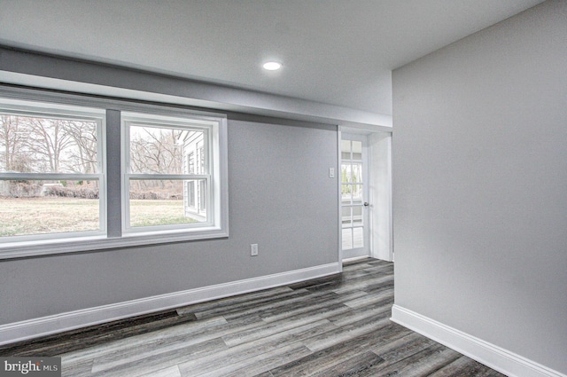 empty room with dark hardwood / wood-style flooring