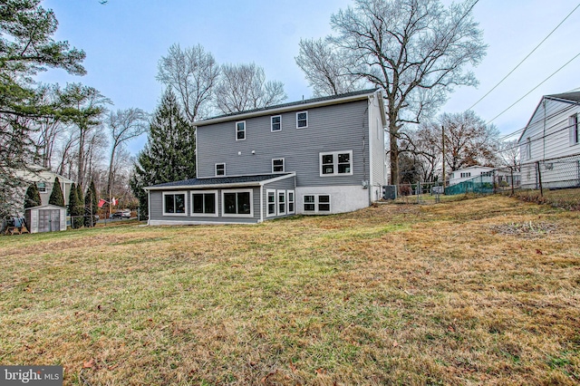 back of property featuring a lawn