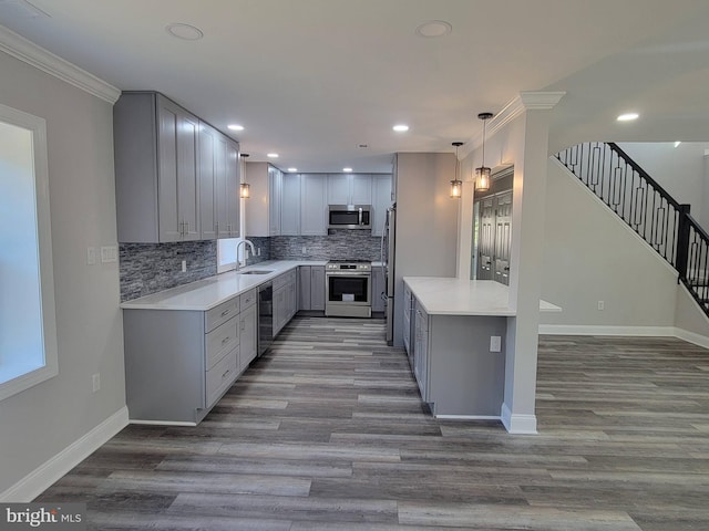 kitchen with gray cabinets, ornamental molding, sink, and appliances with stainless steel finishes