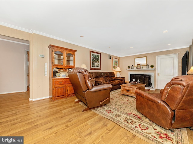 living room with light hardwood / wood-style floors and crown molding