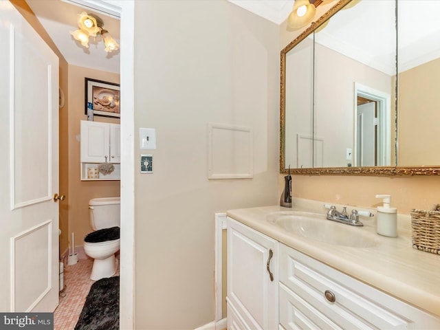 bathroom with tile patterned flooring, vanity, toilet, and ornamental molding