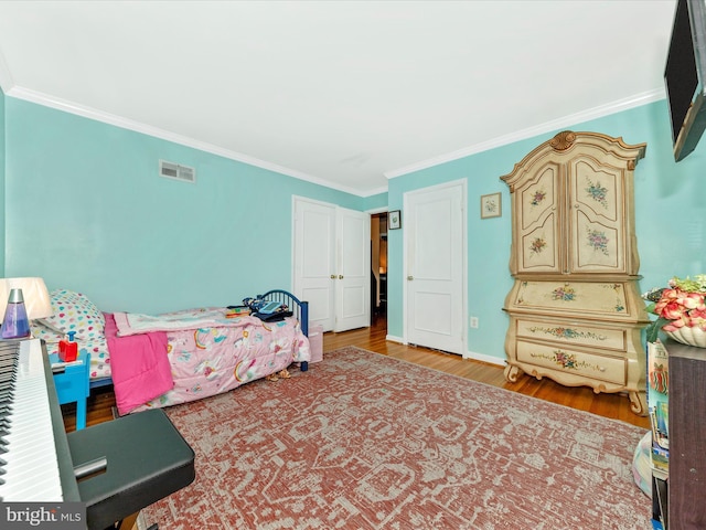 bedroom featuring hardwood / wood-style floors and ornamental molding