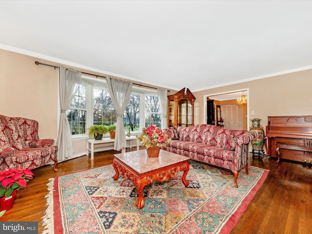 living room with crown molding, dark hardwood / wood-style flooring, and a chandelier