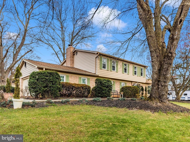 view of front of house with a garage and a front lawn