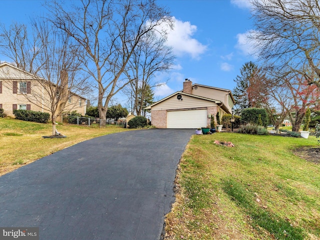 view of front of house with a garage and a front yard