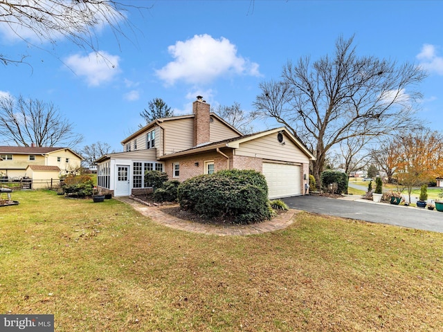 exterior space featuring a lawn and a garage