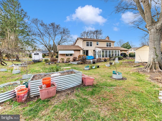 back of property featuring a lawn and a shed