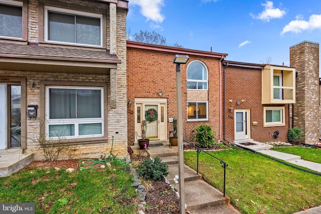 8111 Bird Ln, Greenbelt, MD 20770 - townhome / multi-family property with a front yard, entry steps, and brick siding