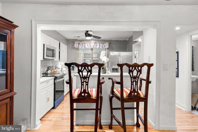 8111 Bird Ln, Greenbelt, MD 20770 - dining area with light wood-style flooring and ceiling fan