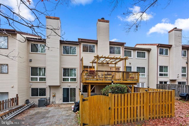 8111 Bird Ln, Greenbelt, MD 20770 - rear view of house with a chimney, a gate, a pergola, a wooden deck, and a patio area