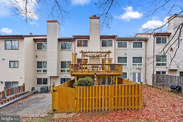8111 Bird Ln, Greenbelt, MD 20770 - back of house with a pergola, a gate, a chimney, and a deck