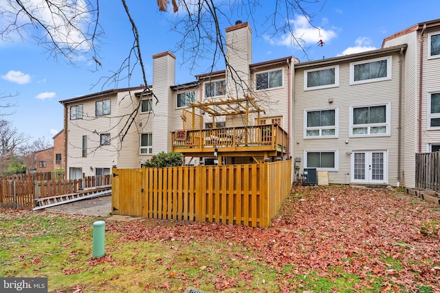 8111 Bird Ln, Greenbelt, MD 20770 - back of house featuring a chimney, french doors, and a wooden deck