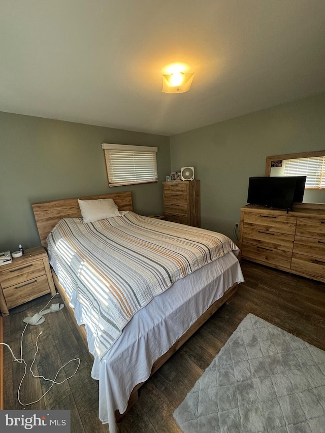 bedroom with dark hardwood / wood-style flooring