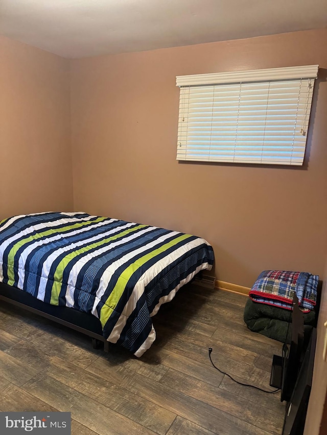 bedroom featuring dark wood-type flooring