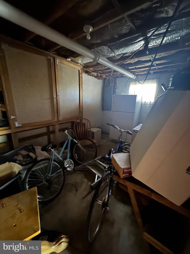 basement featuring white fridge