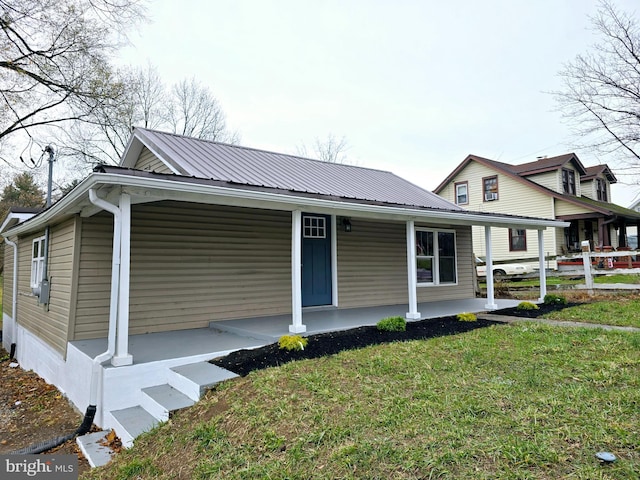 view of front of property with a front yard and covered porch