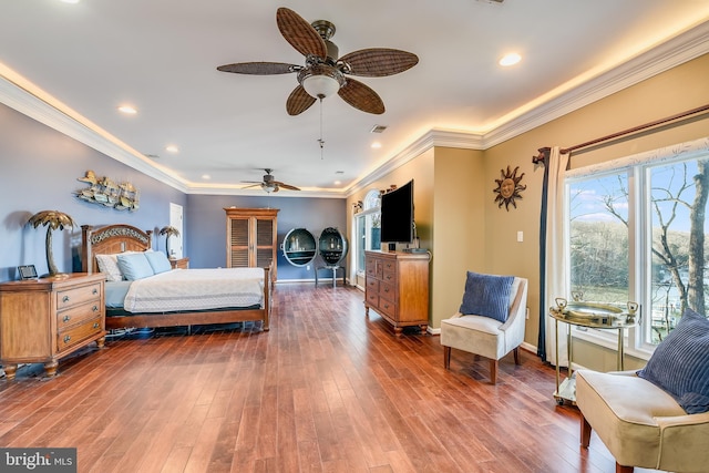 bedroom with ceiling fan, ornamental molding, and hardwood / wood-style flooring