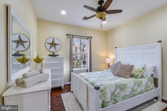 bedroom with dark hardwood / wood-style floors and ceiling fan