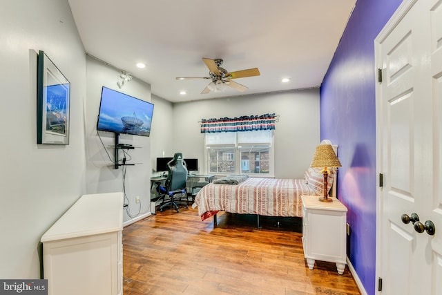 bedroom with light hardwood / wood-style flooring and ceiling fan