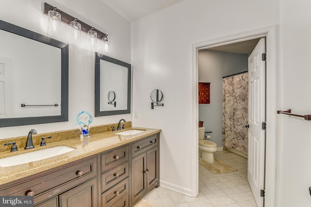 bathroom with tile patterned floors, vanity, and toilet