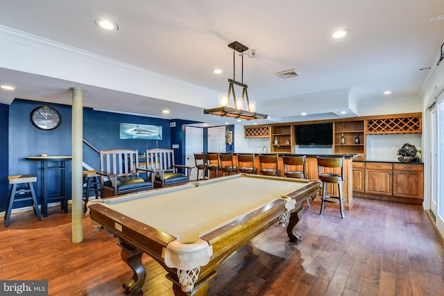 playroom featuring ornamental molding, bar, dark wood-type flooring, and billiards