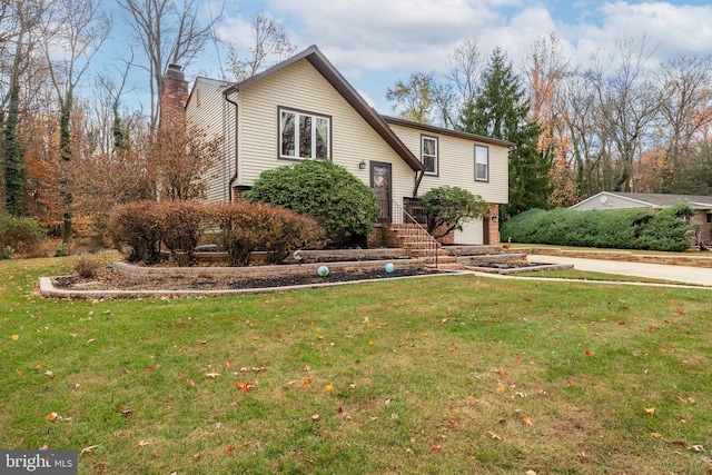 view of front facade featuring a garage and a front lawn