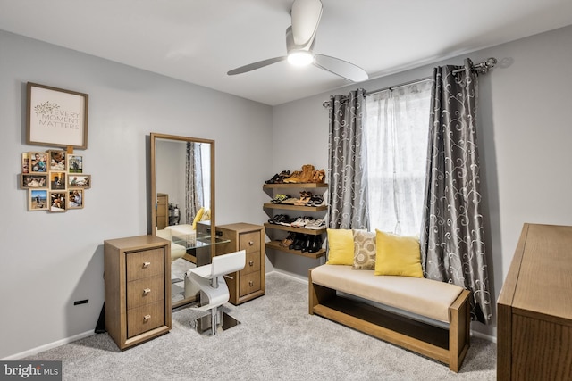 office space featuring ceiling fan and light carpet