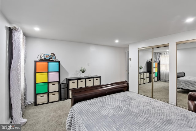 carpeted bedroom featuring two closets