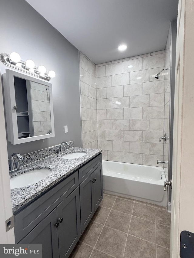 bathroom featuring vanity, tile patterned floors, and tiled shower / bath