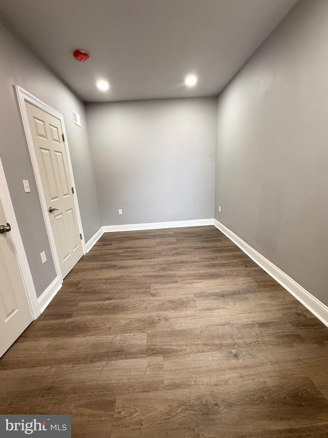 spare room with dark hardwood / wood-style flooring