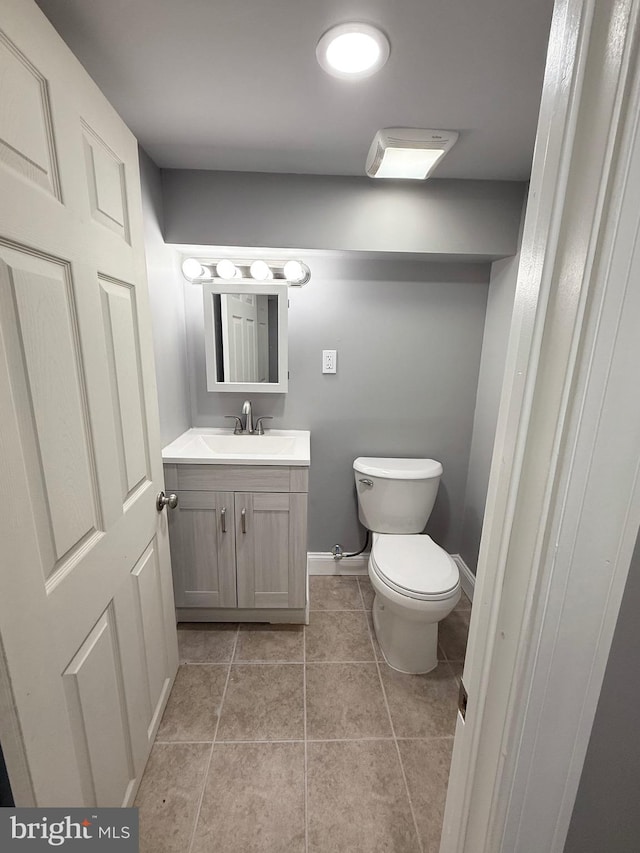 bathroom with tile patterned floors, vanity, and toilet