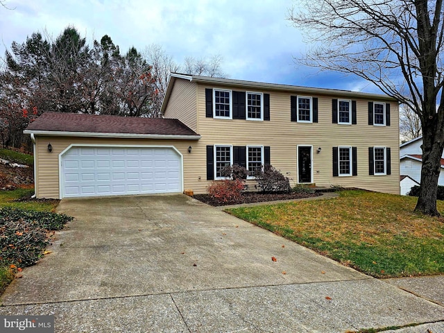 colonial house with a front yard and a garage