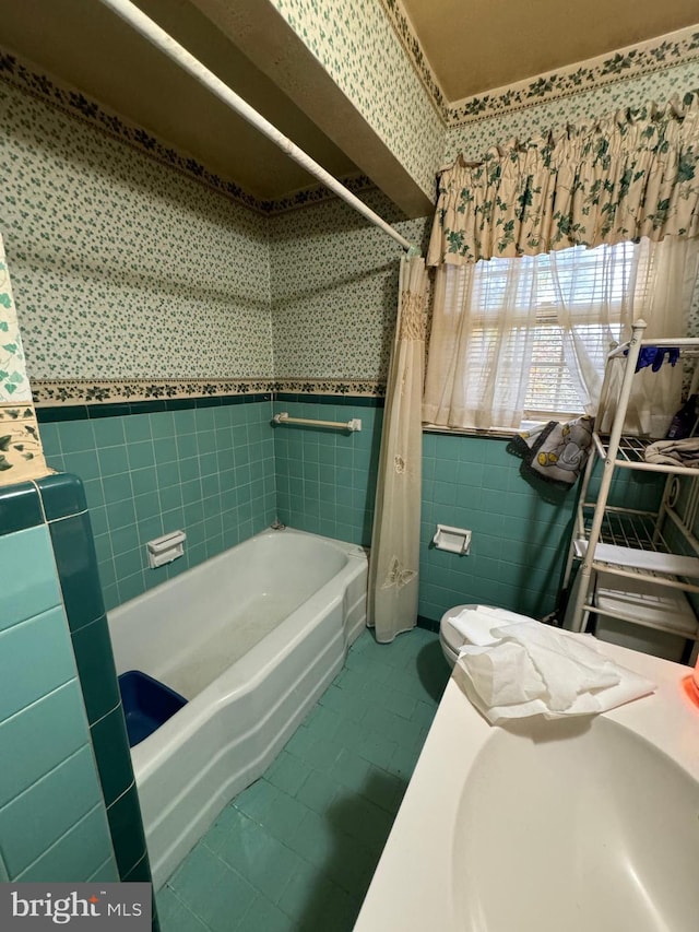 14423 Long Branch Rd, Woodford, VA 22580 - full bathroom featuring tile walls, tile patterned flooring, wallpapered walls, shower / tub combo with curtain, and a wainscoted wall