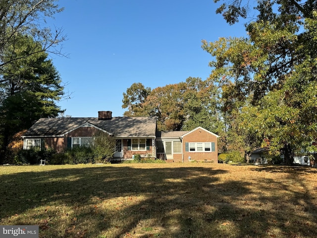 14423 Long Branch Rd, Woodford, VA 22580 - view of front of property with a front lawn, a chimney, and brick siding