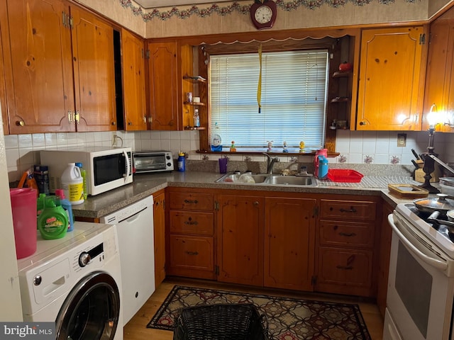 14423 Long Branch Rd, Woodford, VA 22580 - kitchen featuring a sink, washer / dryer, white appliances, brown cabinetry, and tasteful backsplash