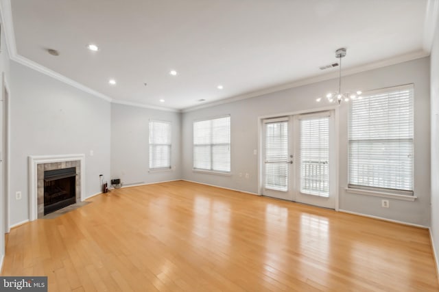 unfurnished living room with a fireplace, light wood-type flooring, and ornamental molding