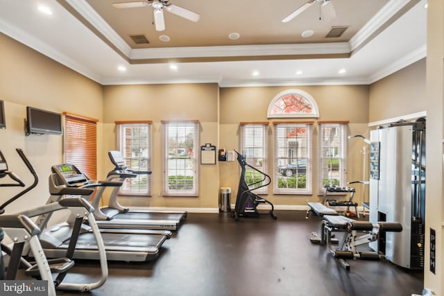 workout area with a raised ceiling, crown molding, and ceiling fan