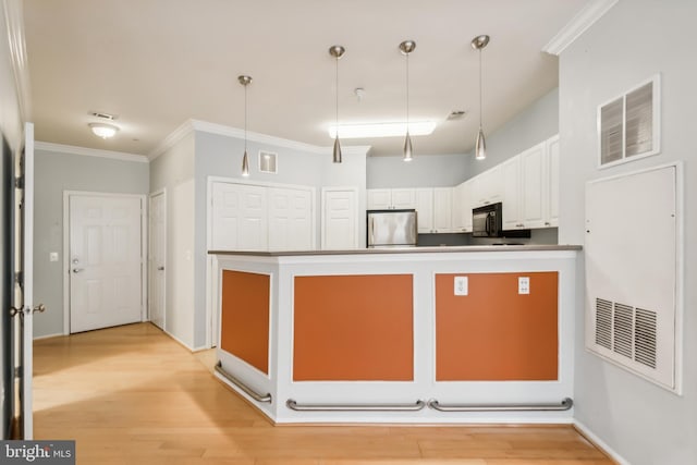 kitchen featuring stainless steel refrigerator, light hardwood / wood-style flooring, pendant lighting, white cabinets, and ornamental molding